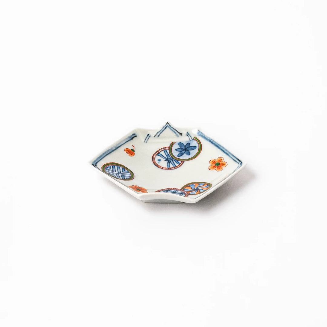 Japanese porcelain origami shaped sauce dish with geometric and floral motifs for soy sauce or condiments.