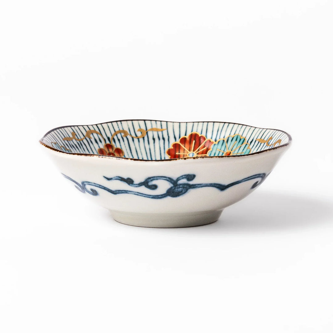 Scalloped Japanese dessert bowl with blue stripes red and teal floral motifs and gold accents for sweets or sides.