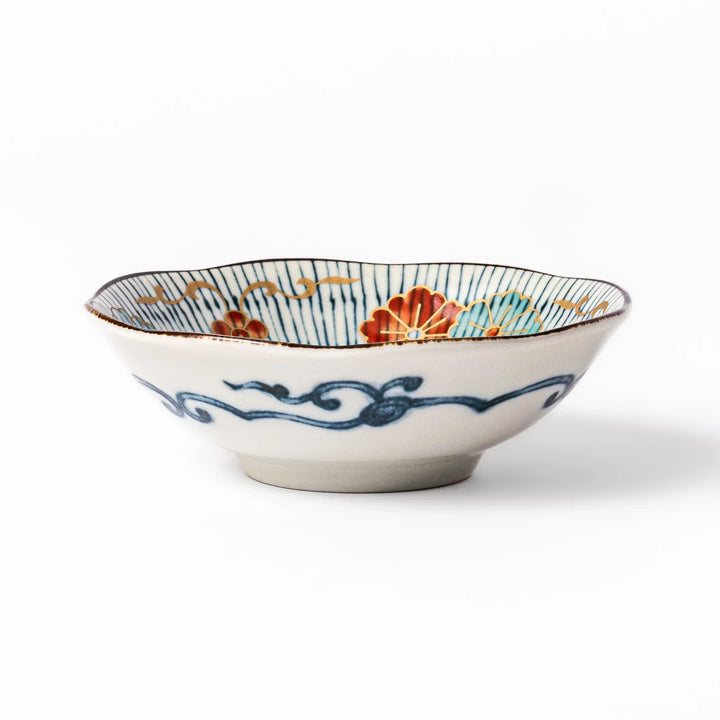Scalloped Japanese dessert bowl with blue stripes red and teal floral motifs and gold accents for sweets or sides.