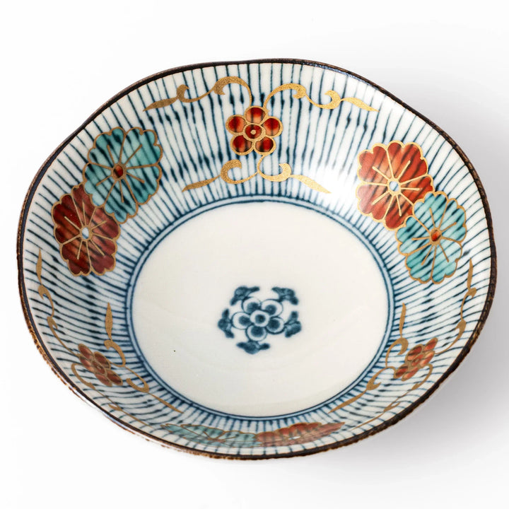 Scalloped Japanese dessert bowl with blue stripes red and teal floral motifs and gold accents for sweets or sides.