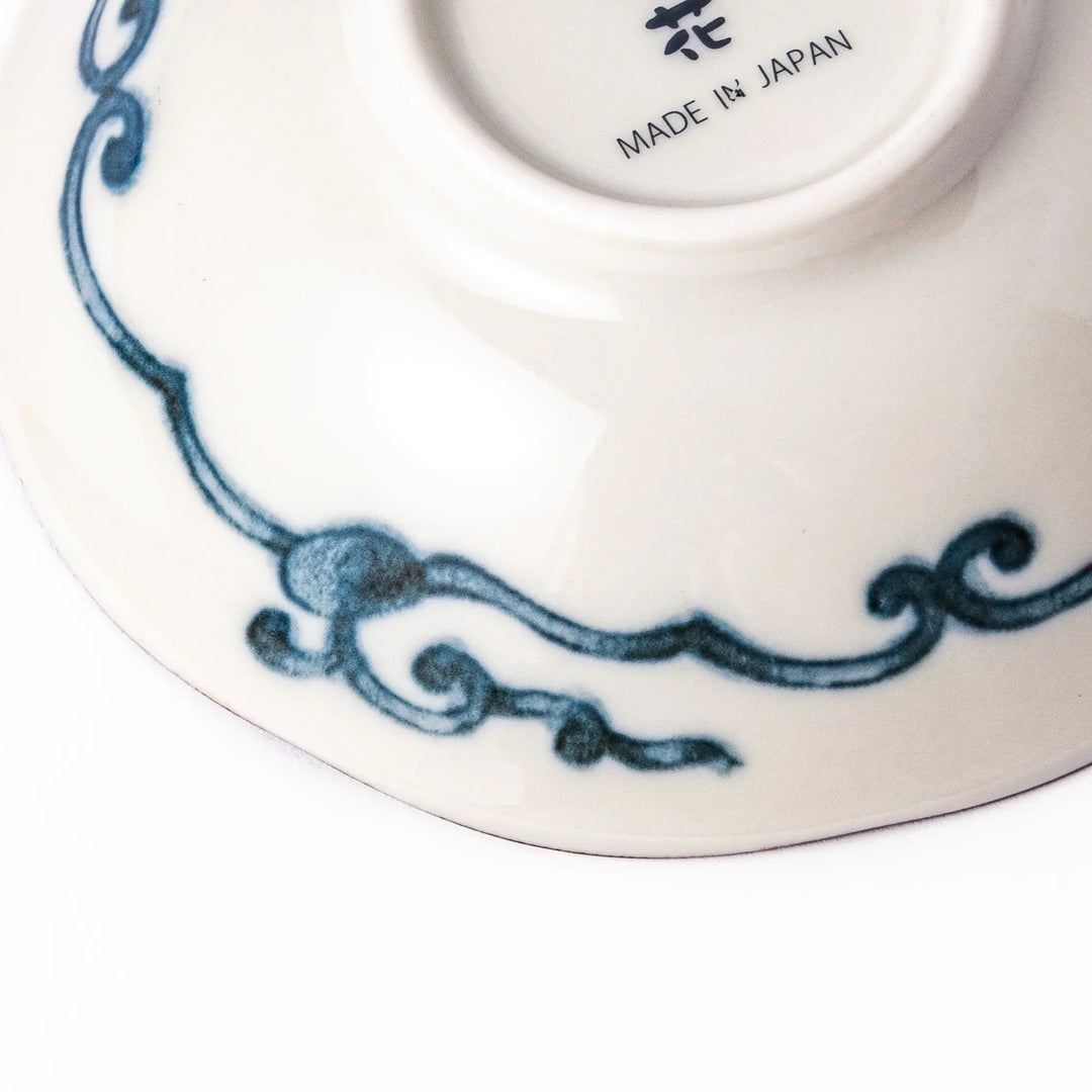 Scalloped Japanese dessert bowl with blue stripes red and teal floral motifs and gold accents for sweets or sides.