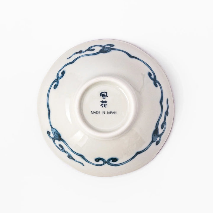 Scalloped Japanese dessert bowl with blue stripes red and teal floral motifs and gold accents for sweets or sides.