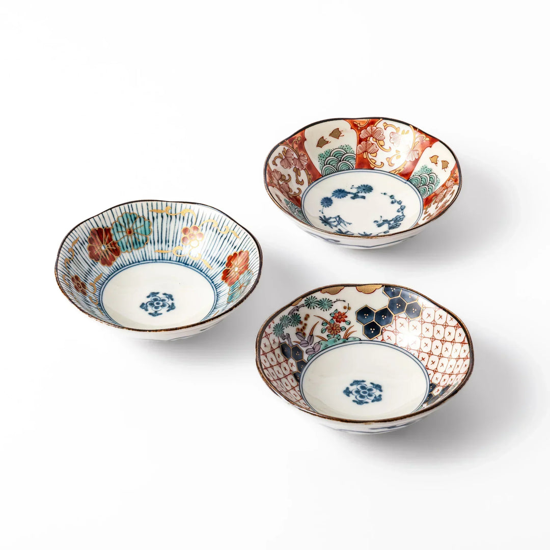 Set of three scalloped Japanese dessert bowls with red blue and gold patterns ideal for sweets or side dishes.