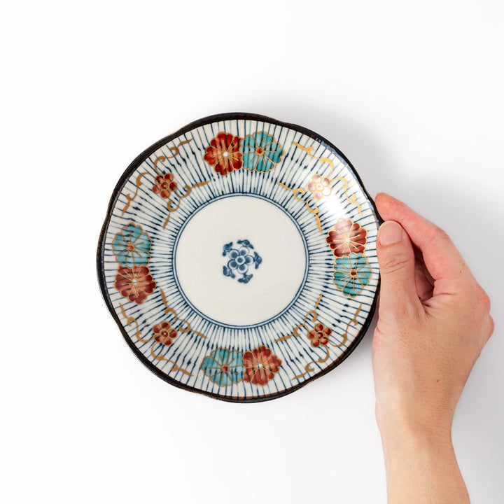 Scalloped Japanese dessert plate with blue stripes red teal and gold floral motifs perfect for small treats.