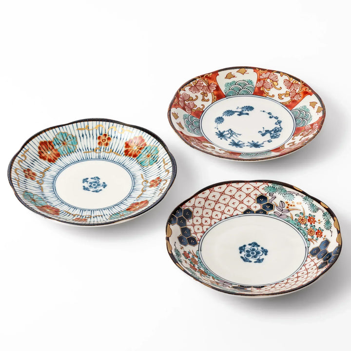 Set of three scalloped Japanese dessert plates with red blue and gold designs perfect for sweets or appetizers.