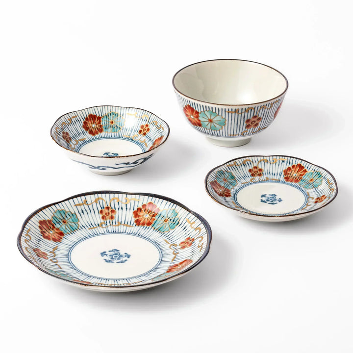 Japanese tableware set with striped floral patterns in red teal and gold including bowls and plates for sides.