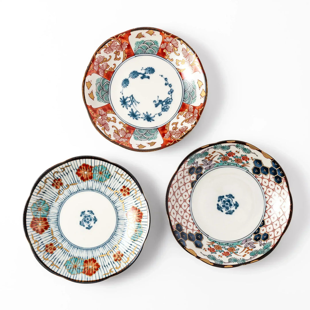 Set of three scalloped Japanese dessert plates with red blue and gold designs perfect for sweets or appetizers.