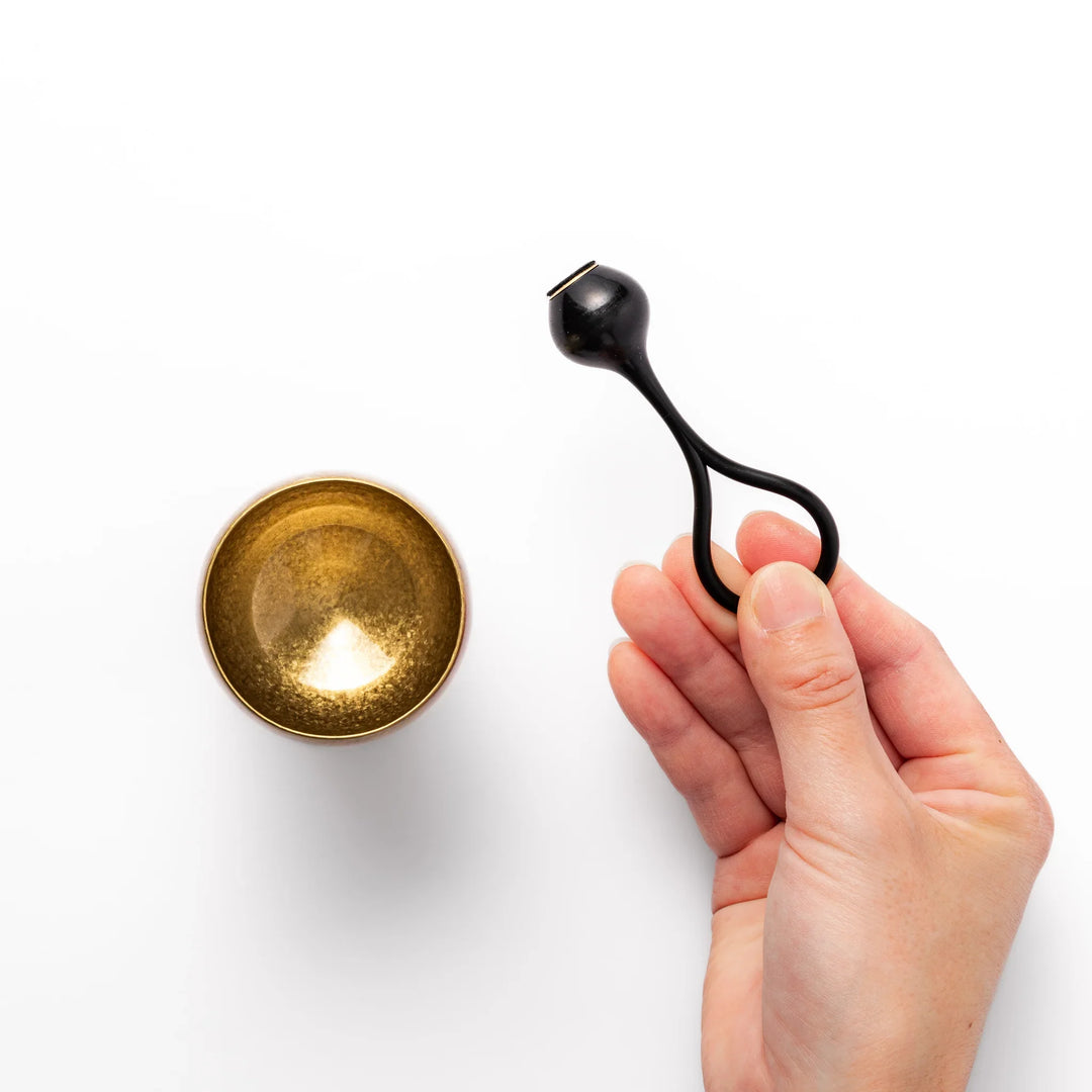 Golden Japanese brass sake cup with rounded base and hammered texture for refined traditional drinking.