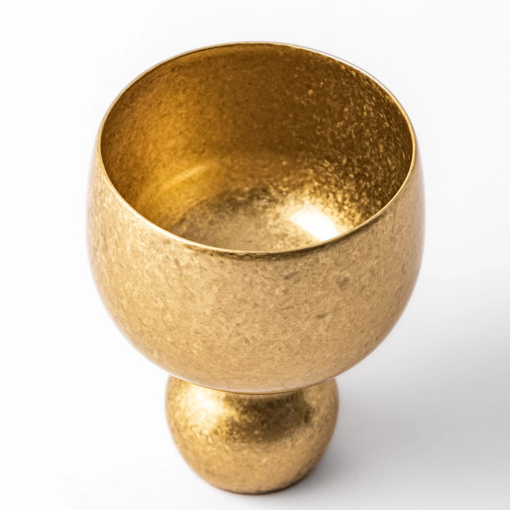 Golden Japanese brass sake cup with rounded base and hammered texture for refined traditional drinking.