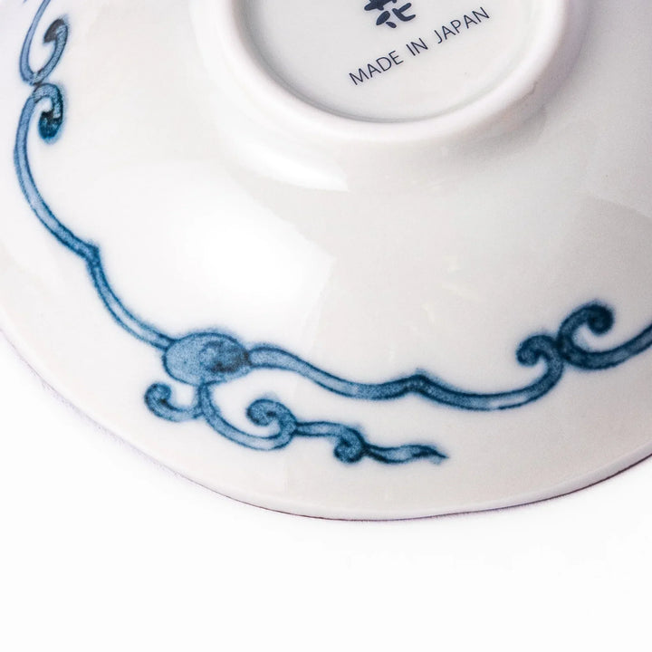 Scalloped Japanese dessert bowl with red lattice navy hexagons and floral accents for traditional dining.