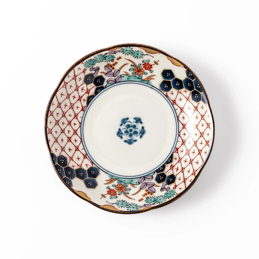 Scalloped Japanese sauce dish with red lattice floral motifs and navy hexagon accents for traditional dining.