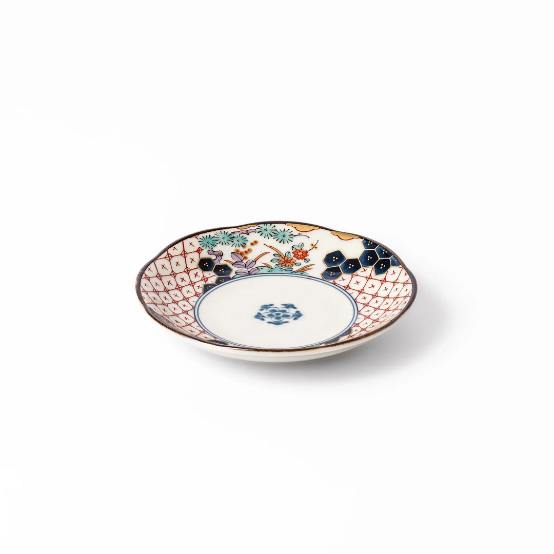 Scalloped Japanese sauce dish with red lattice floral motifs and navy hexagon accents for traditional dining.