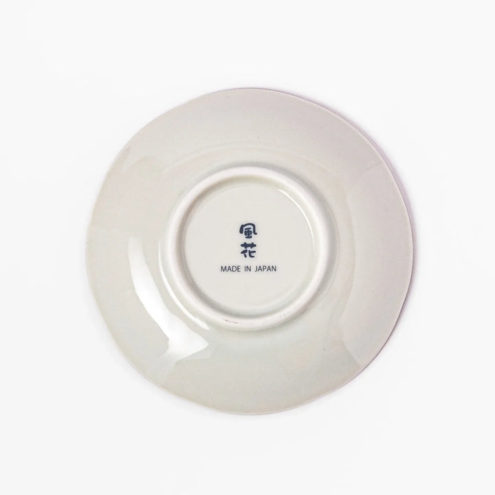 Scalloped Japanese sauce dish with red lattice floral motifs and navy hexagon accents for traditional dining.