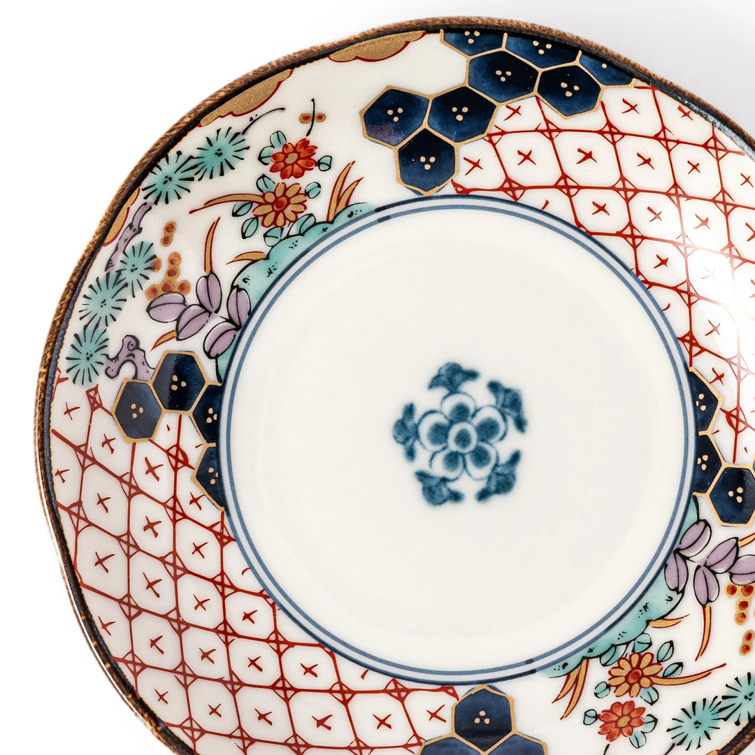 Scalloped Japanese sauce dish with red lattice floral motifs and navy hexagon accents for traditional dining.