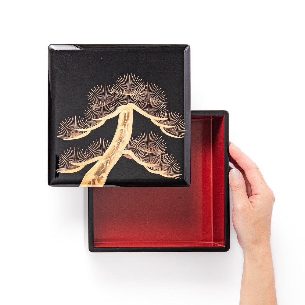 Golden Pine Japanese three tier jubako box with gold pine tree on black lacquer for festive occasions.