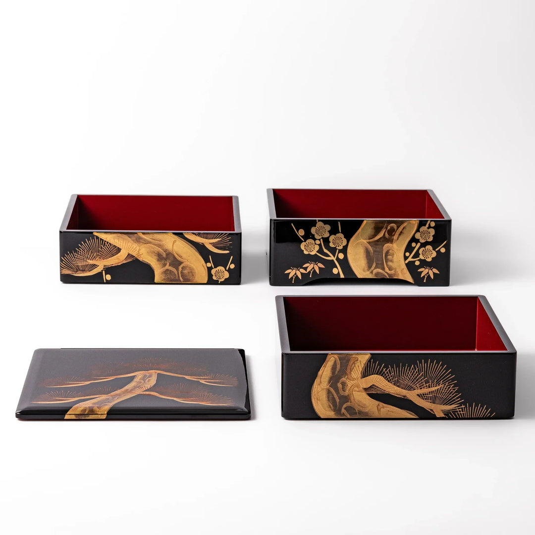 Golden Pine Japanese three tier jubako box with gold pine tree on black lacquer for festive occasions.