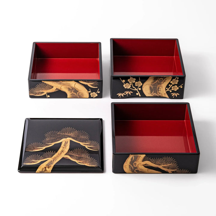 Golden Pine Japanese three tier jubako box with gold pine tree on black lacquer for festive occasions.