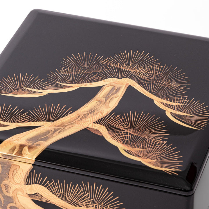 Golden Pine Japanese three tier jubako box with gold pine tree on black lacquer for festive occasions.