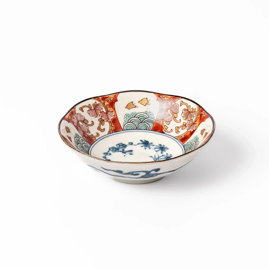 Scalloped Japanese dessert bowl with red green and gold patterns and blue floral center for elegant dining.