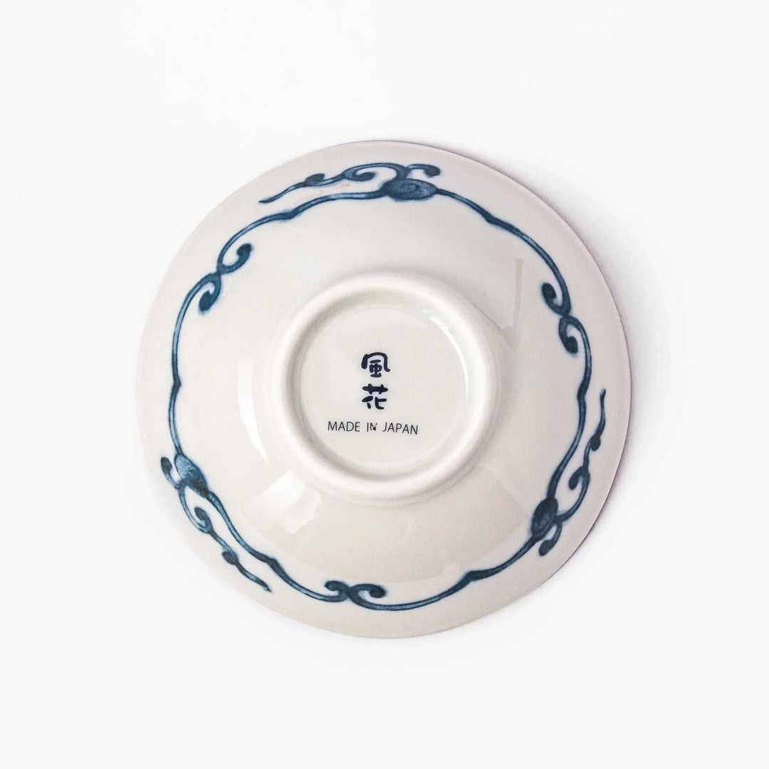 Scalloped Japanese dessert bowl with red green and gold patterns and blue floral center for elegant dining.