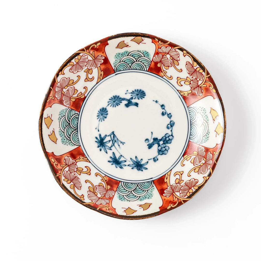 Elegant Japanese dessert plate with scalloped edge blue floral center and red gold and green patterns for refined dining.