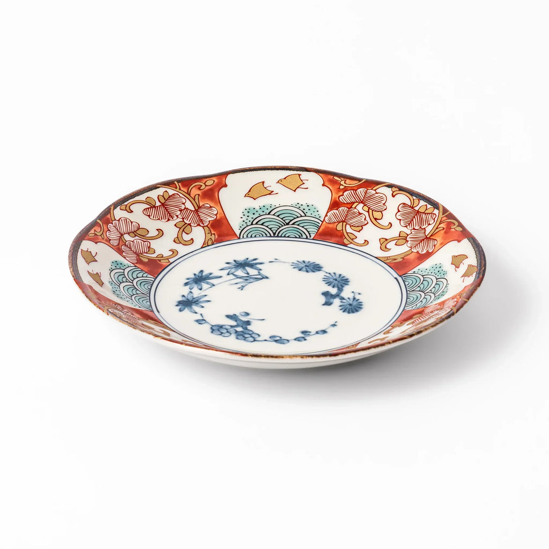Elegant Japanese dessert plate with scalloped edge blue floral center and red gold and green patterns for refined dining.
