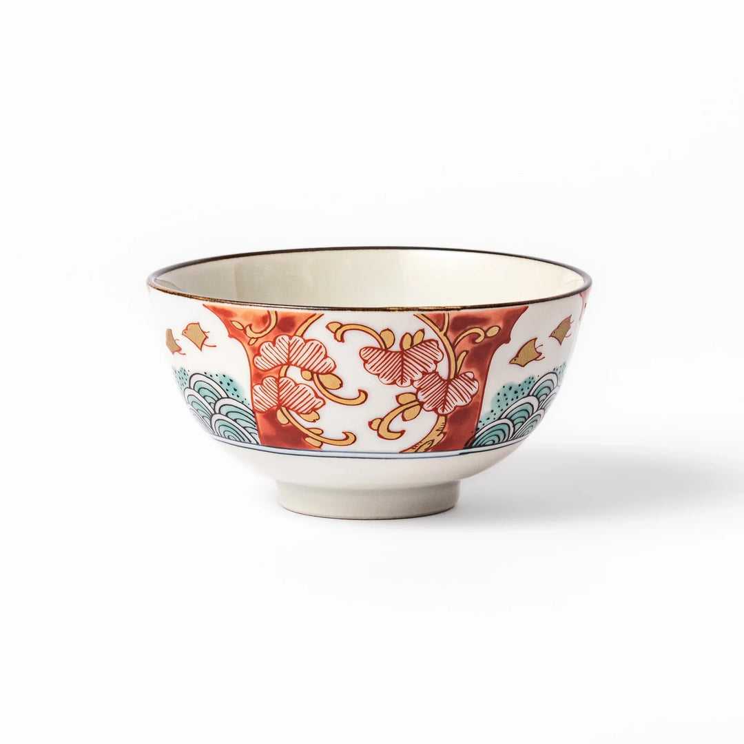 Traditional Japanese rice bowl with red green and gold motifs featuring waves florals and birds for refined meals.