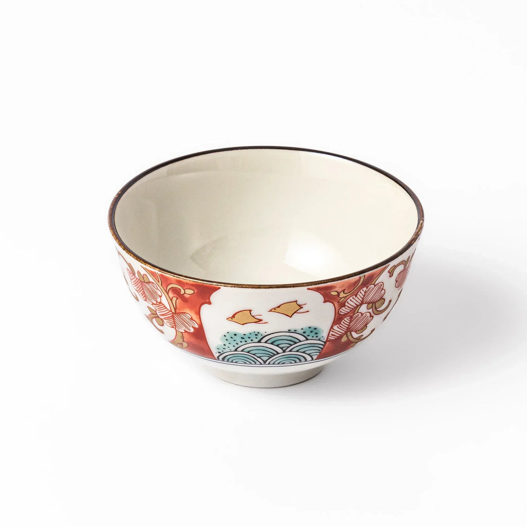 Traditional Japanese rice bowl with red green and gold motifs featuring waves florals and birds for refined meals.