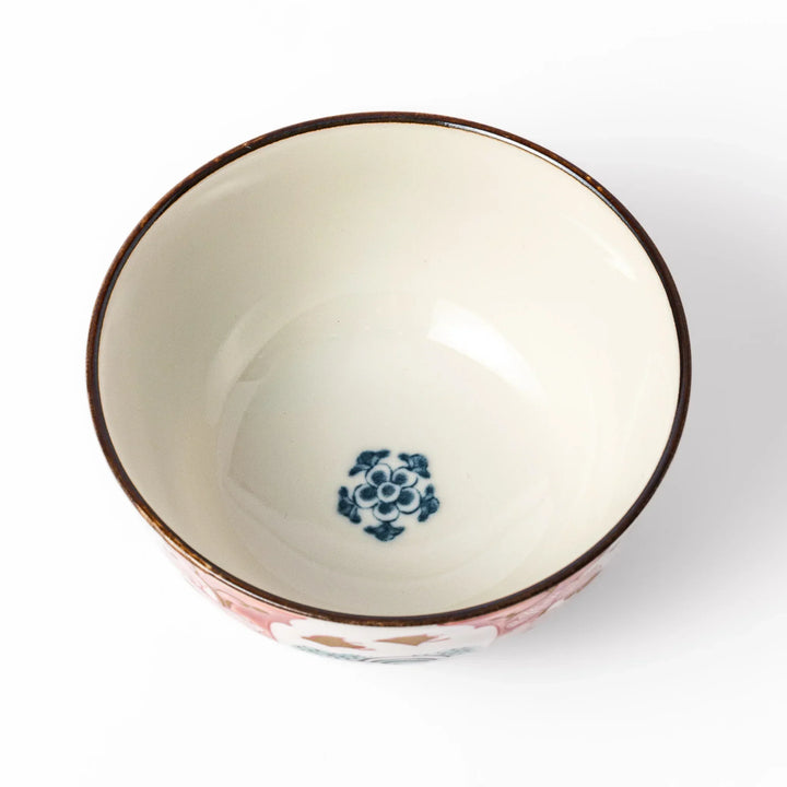 Traditional Japanese rice bowl with red green and gold motifs featuring waves florals and birds for refined meals.