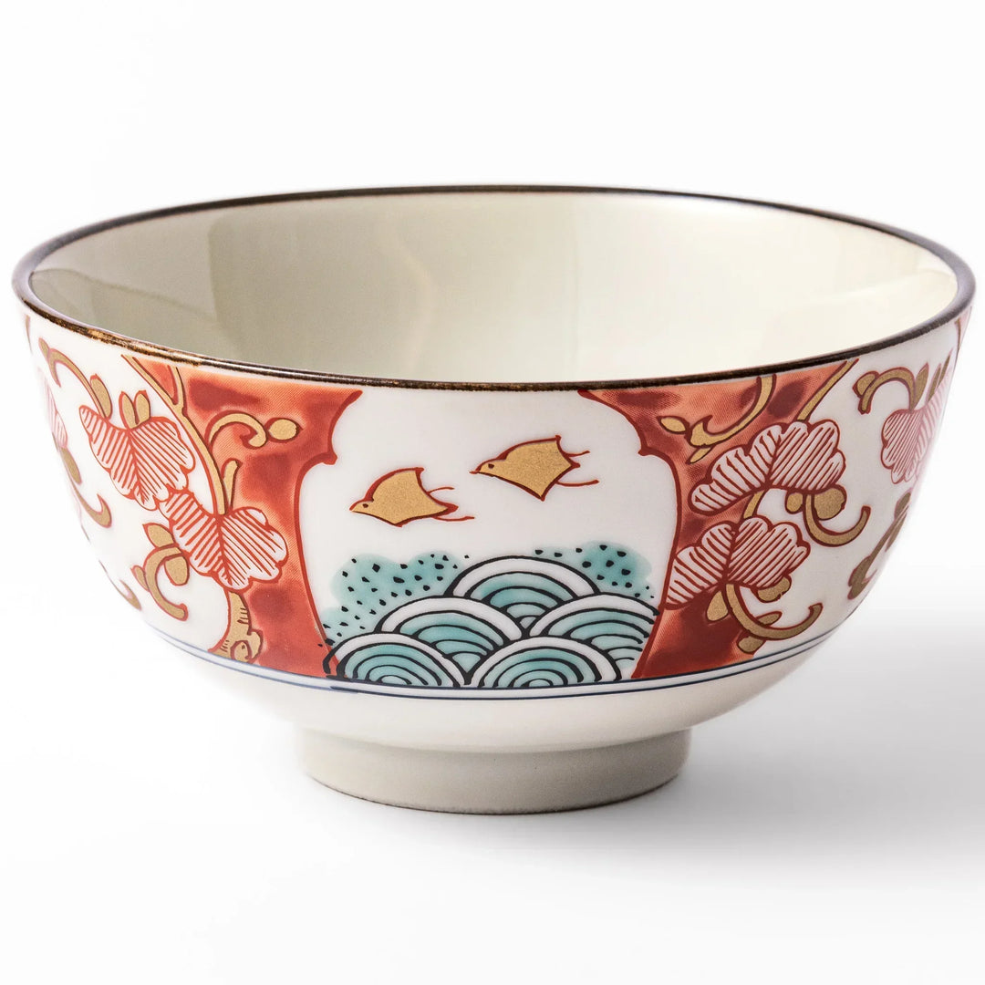 Traditional Japanese rice bowl with red green and gold motifs featuring waves florals and birds for refined meals.