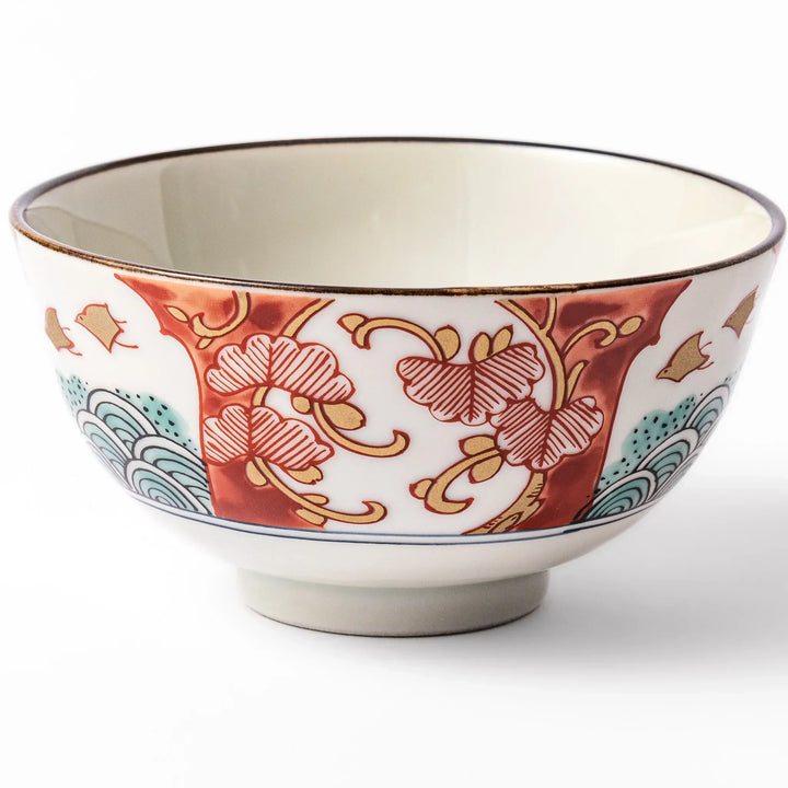 Traditional Japanese rice bowl with red green and gold motifs featuring waves florals and birds for refined meals.
