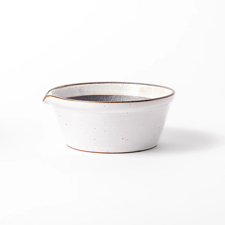 White Japanese ceramic suribachi bowl with smooth dark interior and spout for elegant effortless grinding.