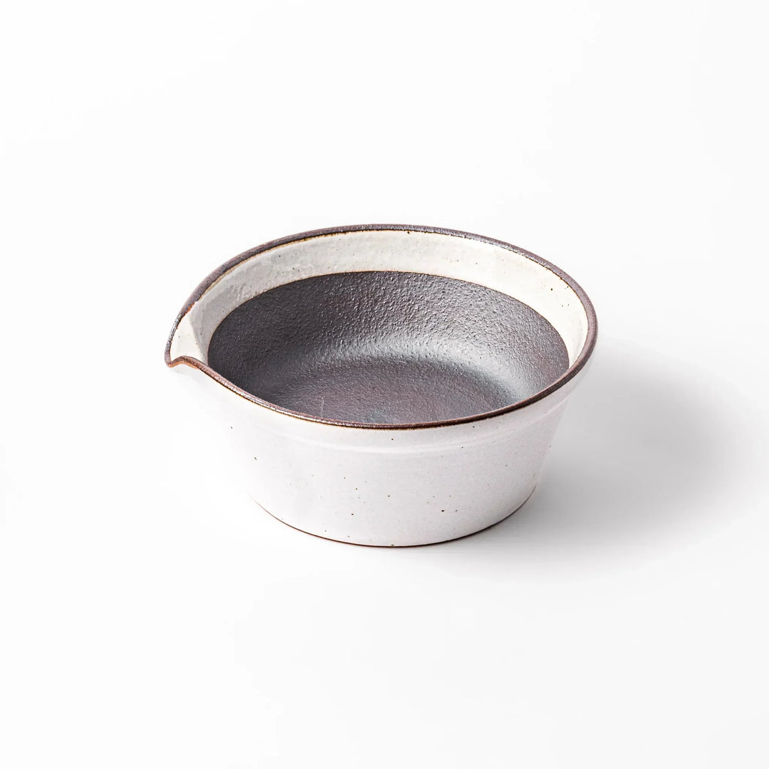 White ceramic suribachi mortar bowl with a smooth dark interior and spout, designed for effortless grinding and elegant table presentation.