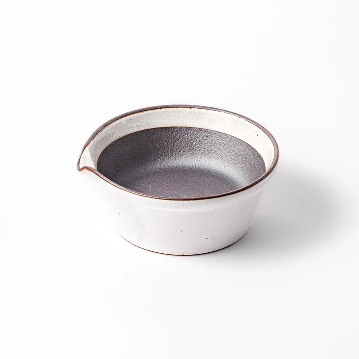 White ceramic suribachi mortar bowl with a smooth dark interior and spout, designed for effortless grinding and elegant table presentation.
