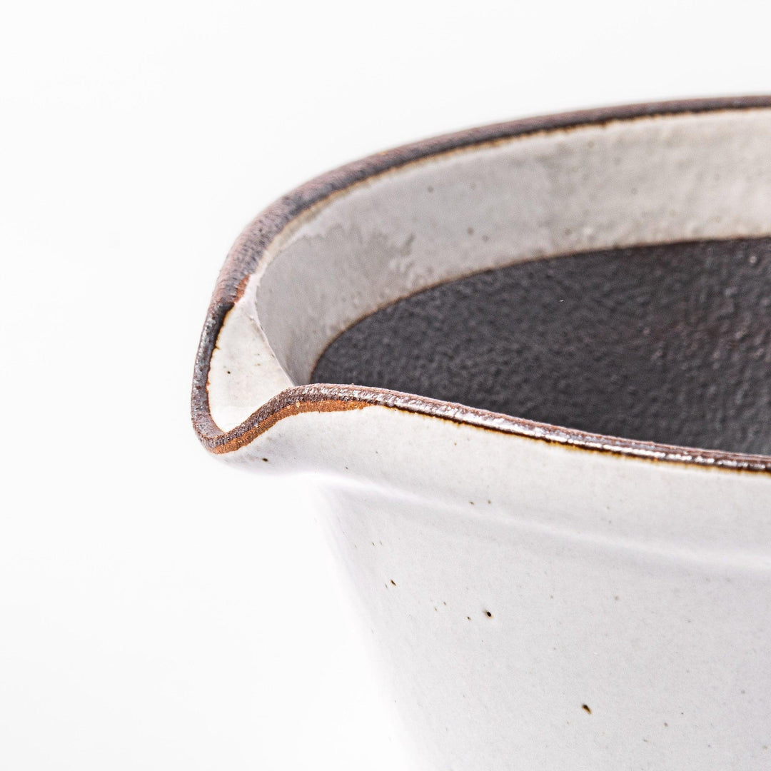 White Japanese ceramic suribachi bowl with smooth dark interior and spout for elegant effortless grinding.