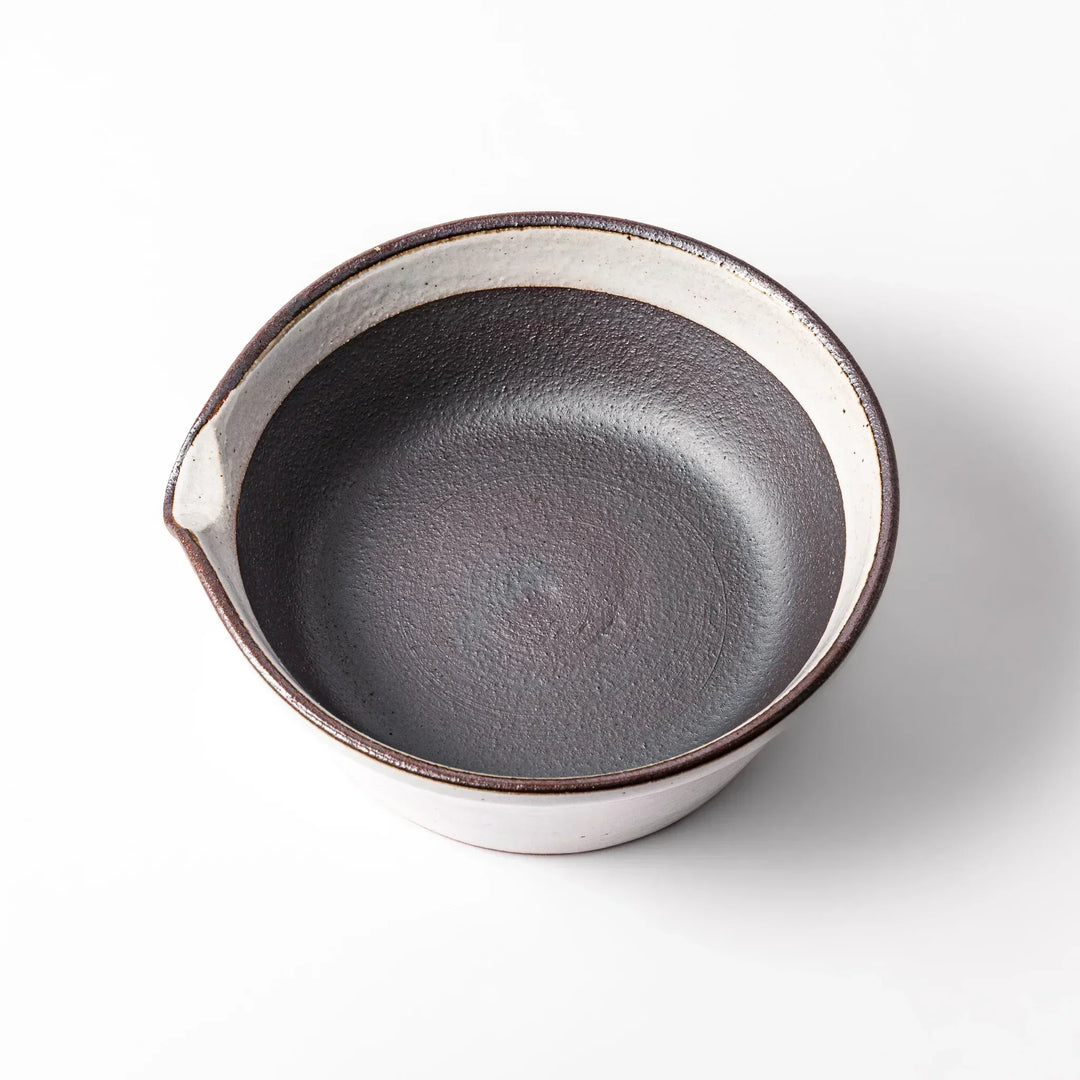 White Japanese ceramic suribachi bowl with smooth dark interior and spout for elegant effortless grinding.