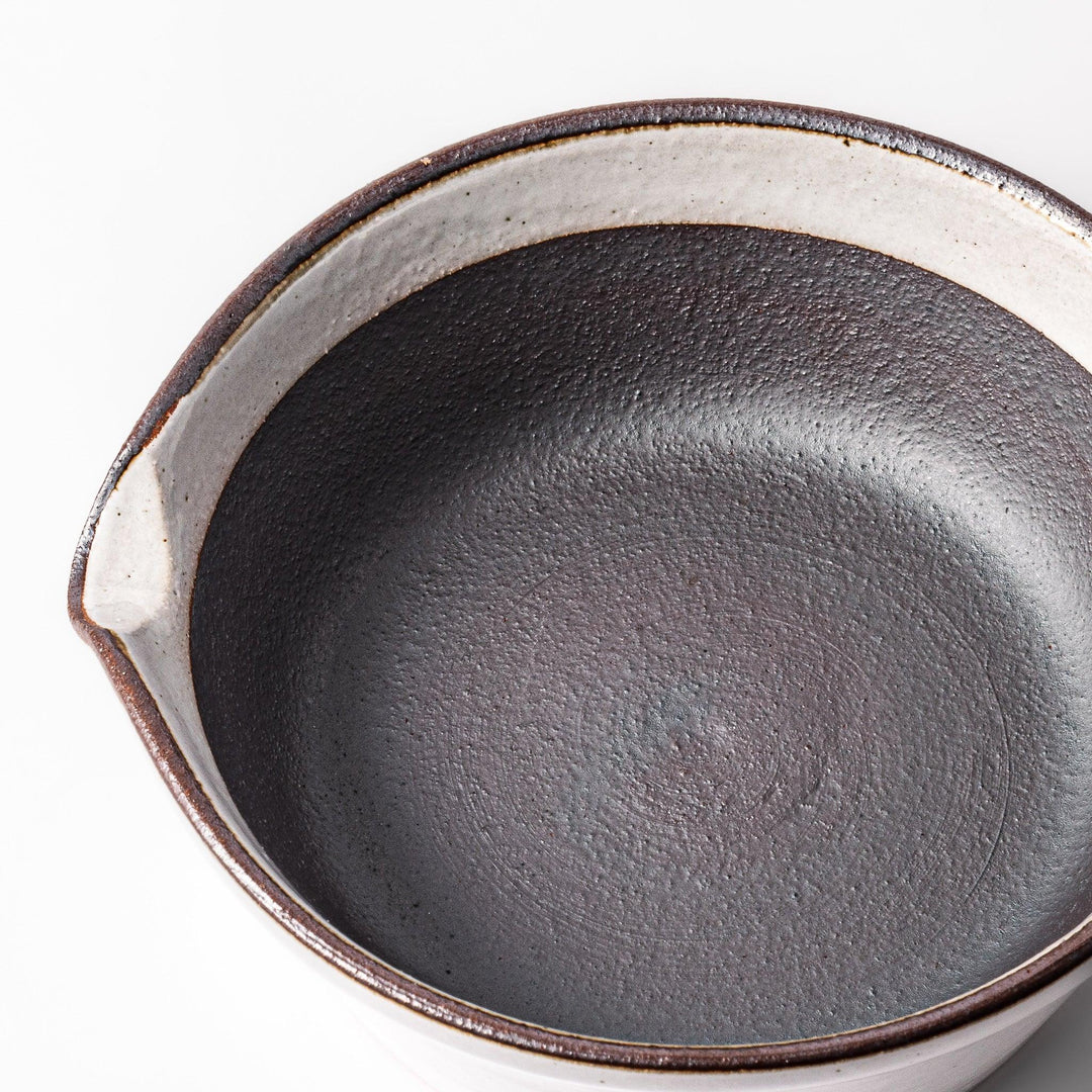 White Japanese ceramic suribachi bowl with smooth dark interior and spout for elegant effortless grinding.
