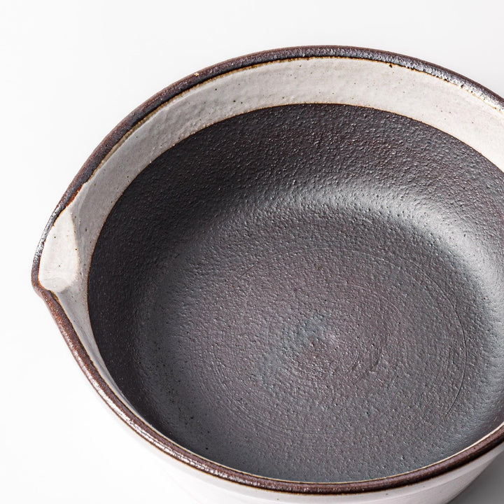 White Japanese ceramic suribachi bowl with smooth dark interior and spout for elegant effortless grinding.