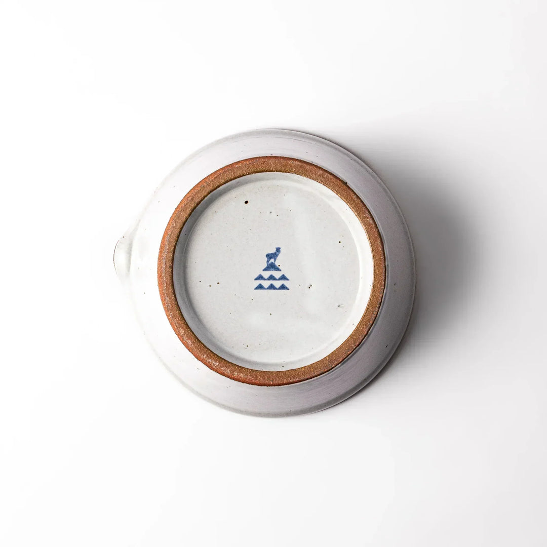 White Japanese ceramic suribachi bowl with smooth dark interior and spout for elegant effortless grinding.