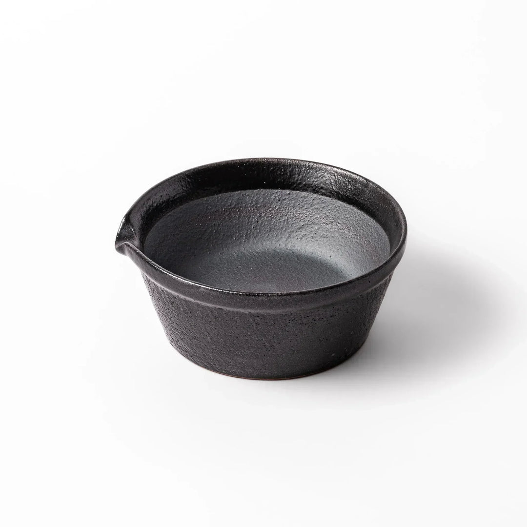 Black Japanese ceramic suribachi bowl with smooth interior and spout for grinding or mixing easy cleanup.