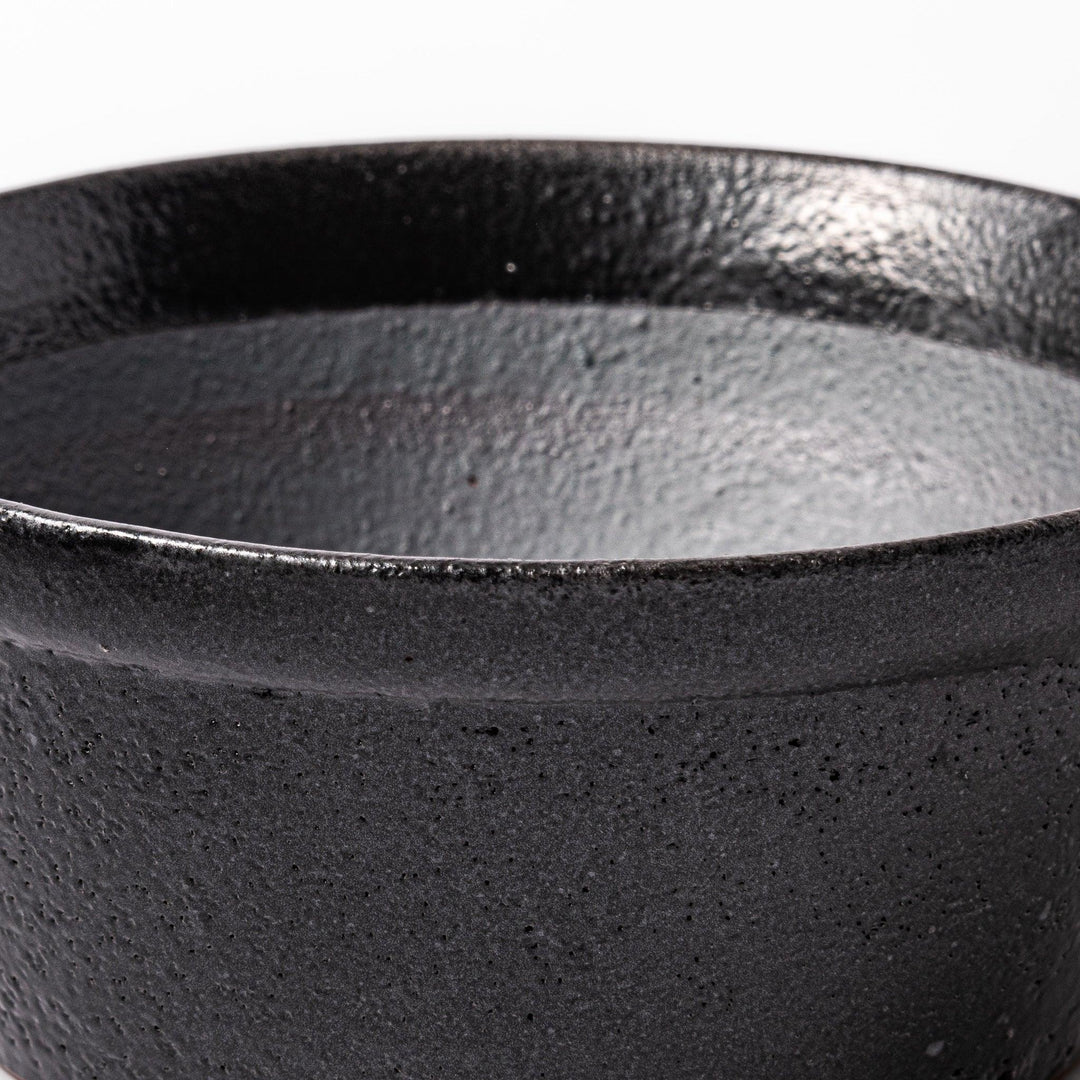 Black Japanese ceramic suribachi bowl with smooth interior and spout for grinding or mixing easy cleanup.