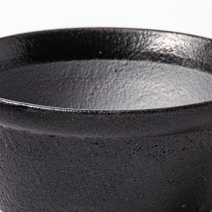 Black Japanese ceramic suribachi bowl with smooth interior and spout for grinding or mixing easy cleanup.