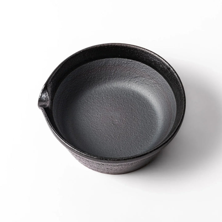 Black Japanese ceramic suribachi bowl with smooth interior and spout for grinding or mixing easy cleanup.