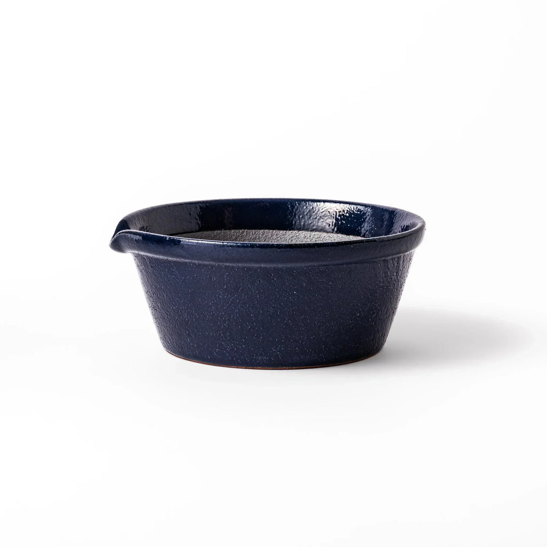 Deep blue Japanese ceramic suribachi bowl with smooth interior and spout for grinding and serving sauces.