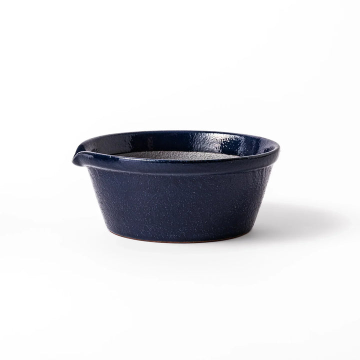 Deep blue Japanese ceramic suribachi bowl with smooth interior and spout for grinding and serving sauces.