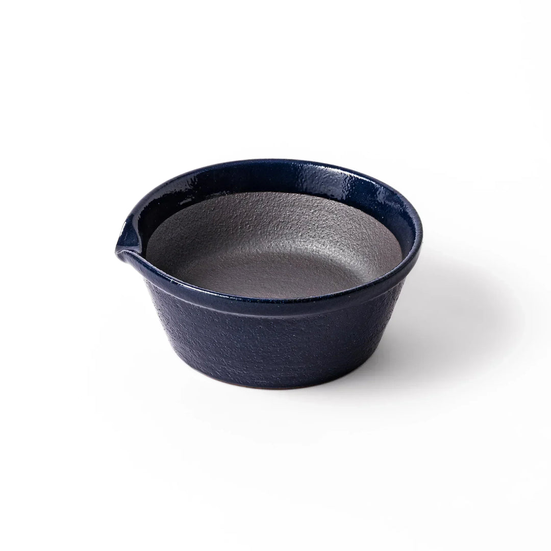 Deep blue Japanese ceramic suribachi bowl with smooth interior and spout for grinding and serving sauces.