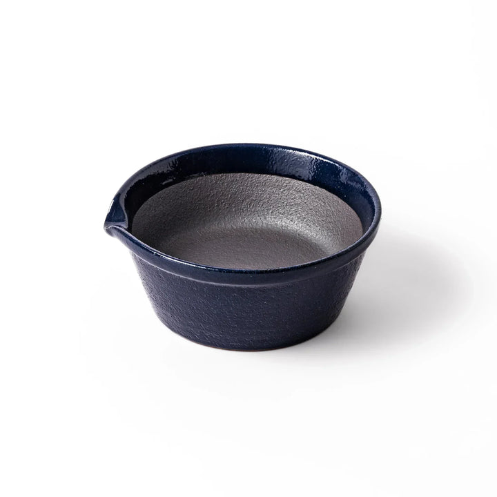 Deep blue Japanese ceramic suribachi bowl with smooth interior and spout for grinding and serving sauces.