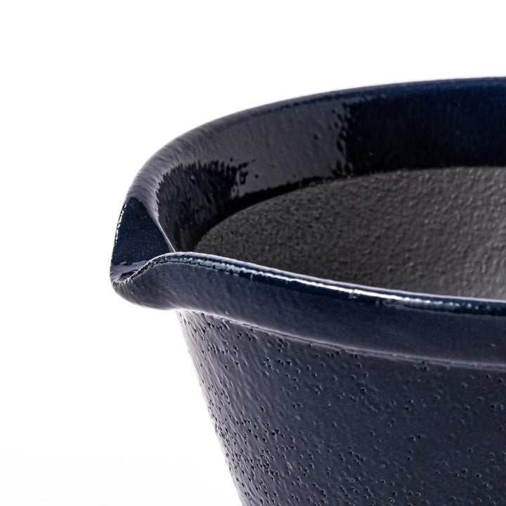 Deep blue Japanese ceramic suribachi bowl with smooth interior and spout for grinding and serving sauces.