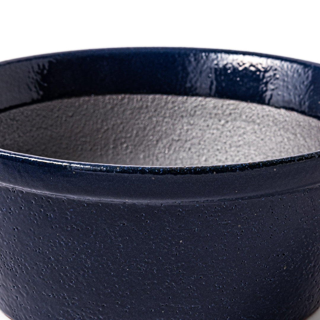 Deep blue Japanese ceramic suribachi bowl with smooth interior and spout for grinding and serving sauces.