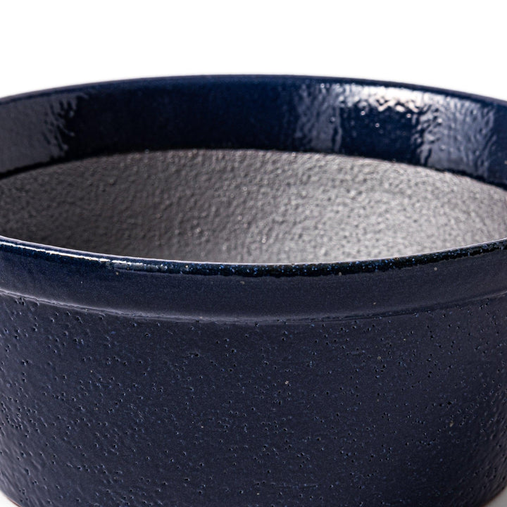 Deep blue Japanese ceramic suribachi bowl with smooth interior and spout for grinding and serving sauces.